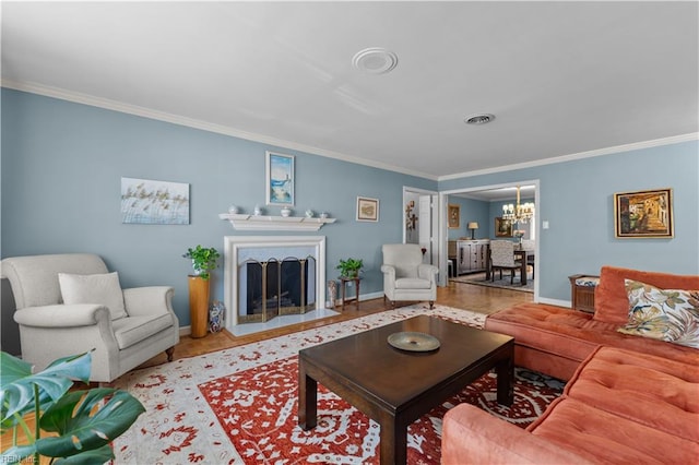 living room featuring ornamental molding and a notable chandelier