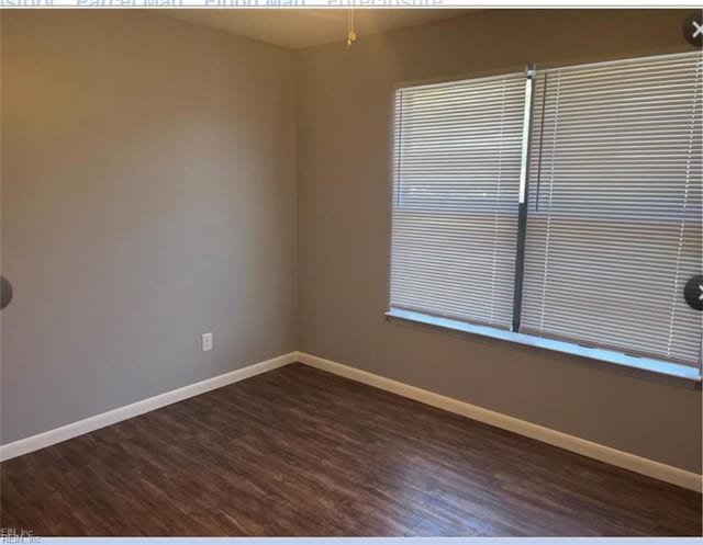 empty room featuring dark hardwood / wood-style flooring