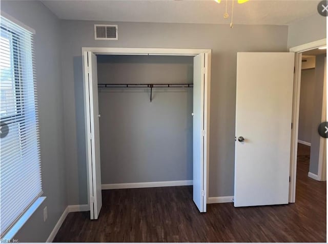 unfurnished bedroom featuring dark hardwood / wood-style floors and a closet