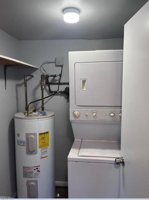 washroom featuring electric water heater and stacked washer / dryer