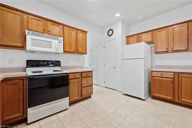 kitchen with light tile patterned flooring and white appliances