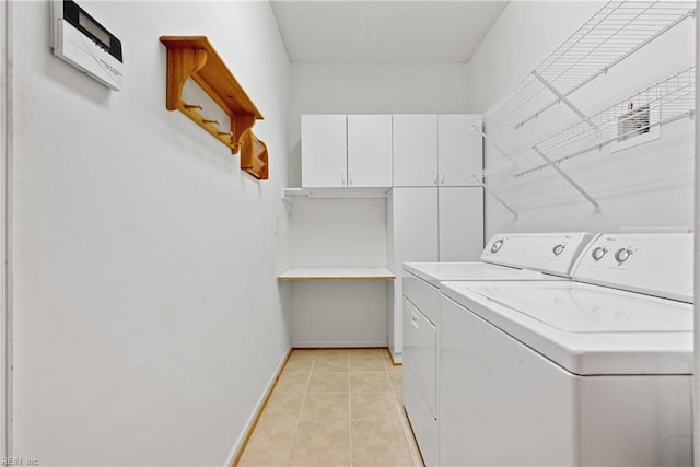 laundry room featuring washer and dryer and light tile patterned flooring