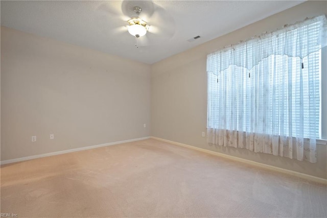 carpeted spare room with ceiling fan