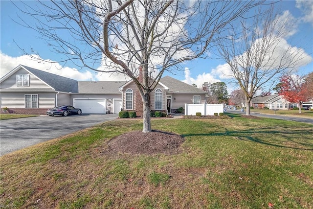 ranch-style house featuring a garage and a front yard