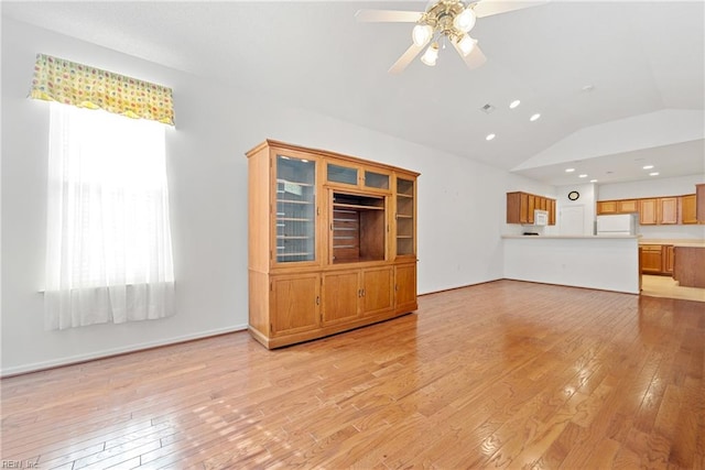 unfurnished living room featuring ceiling fan, light hardwood / wood-style flooring, and lofted ceiling