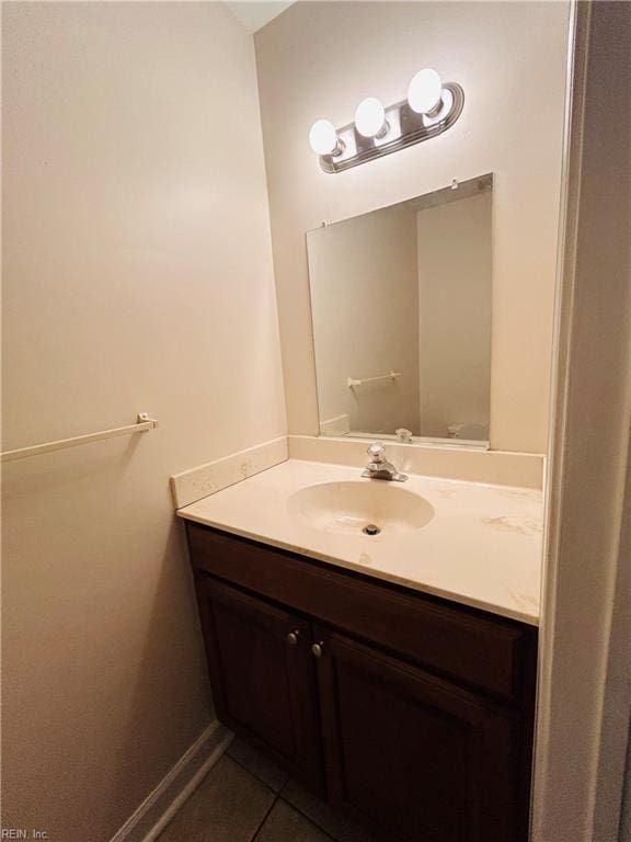 bathroom featuring vanity, baseboards, and tile patterned floors