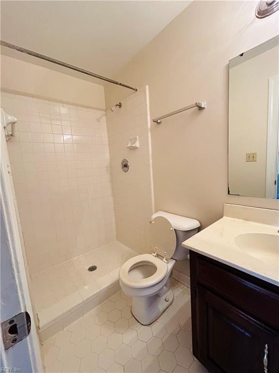 bathroom featuring a stall shower, vanity, and toilet