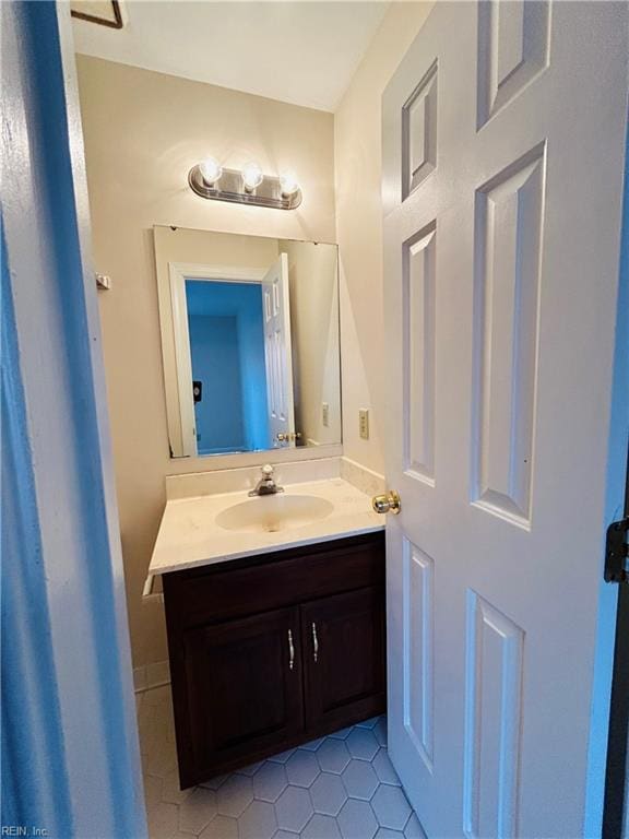 bathroom with tile patterned flooring and vanity