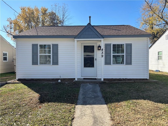 bungalow-style house with a front lawn