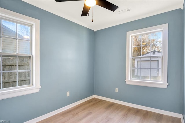 empty room with ceiling fan and light wood-type flooring