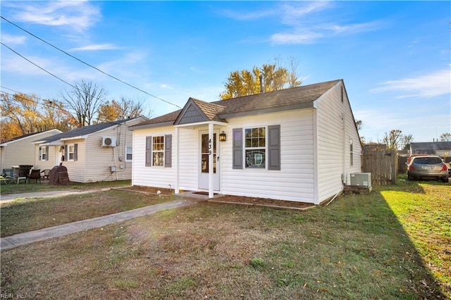 single story home with ac unit and a front lawn