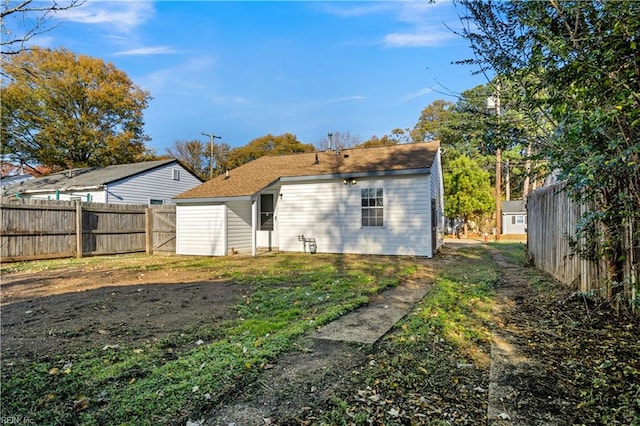 rear view of property with a yard