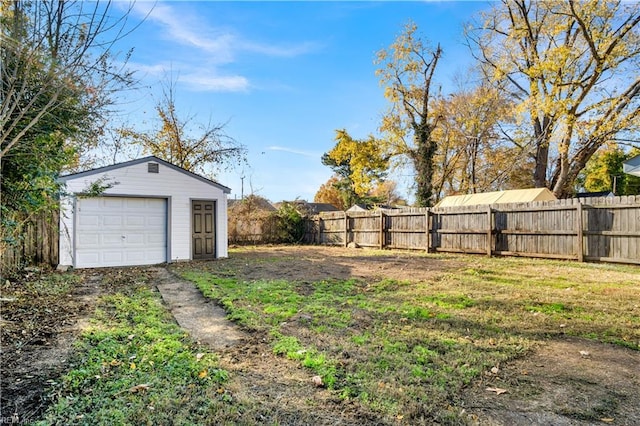 view of yard featuring an outbuilding and a garage