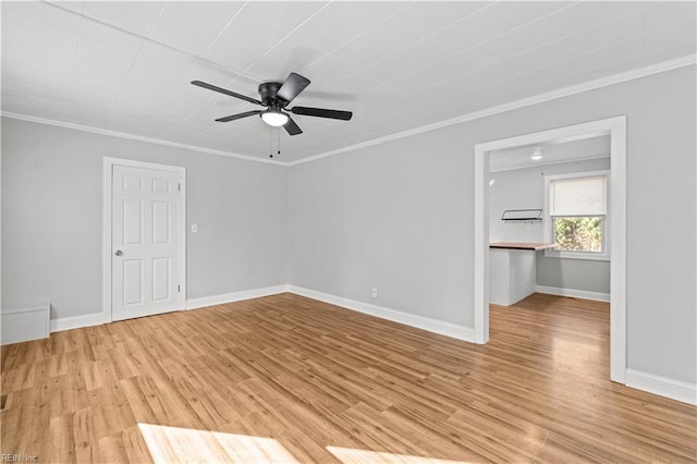 spare room with crown molding, light hardwood / wood-style flooring, and ceiling fan