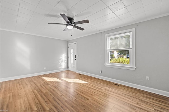 spare room with ceiling fan, crown molding, and light hardwood / wood-style flooring