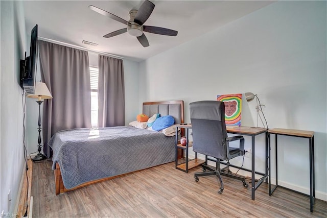 bedroom with hardwood / wood-style flooring and ceiling fan