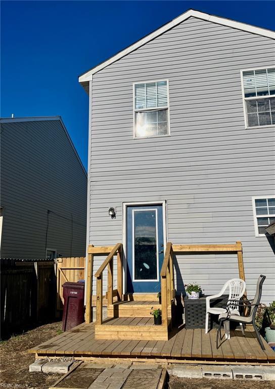 rear view of property featuring a wooden deck