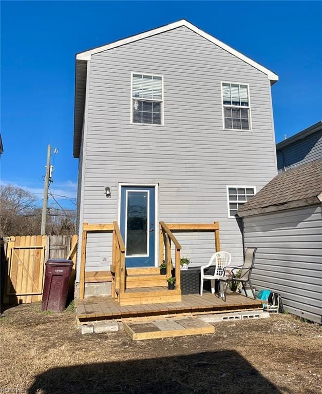 rear view of property featuring a deck