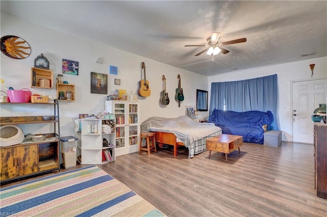 bedroom with ceiling fan and wood-type flooring