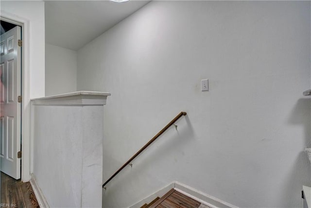 staircase with hardwood / wood-style flooring