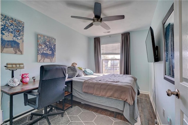 bedroom with ceiling fan and dark wood-type flooring