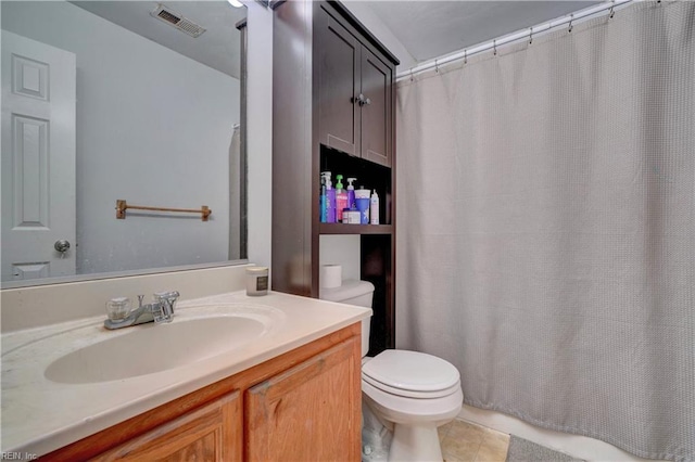 bathroom featuring tile patterned floors, vanity, and toilet