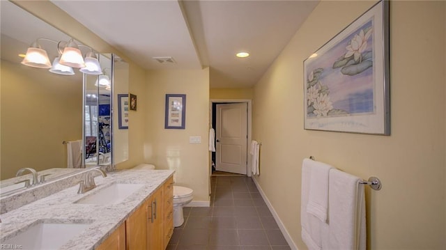 bathroom with tile patterned floors, vanity, toilet, and a chandelier