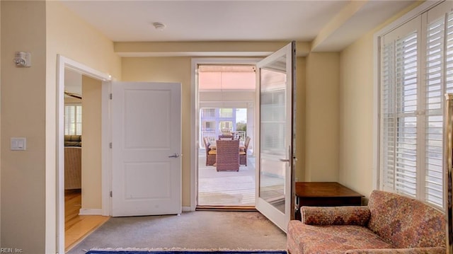 entryway with light colored carpet and french doors