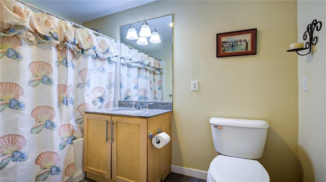 bathroom featuring curtained shower, vanity, and toilet