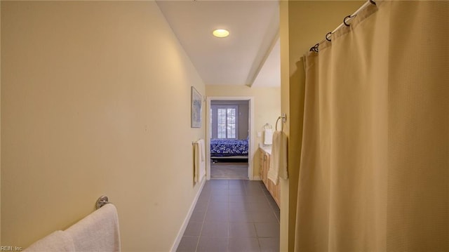 hallway with dark tile patterned floors