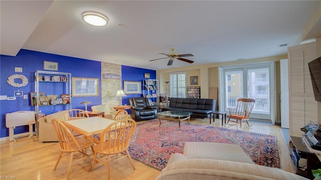 living room featuring ceiling fan, a healthy amount of sunlight, and light hardwood / wood-style flooring