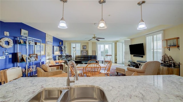 kitchen with light stone counters and a wealth of natural light