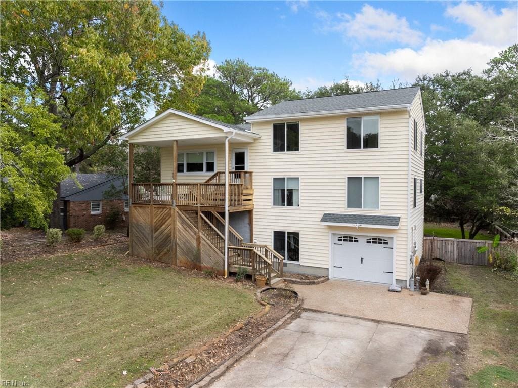 back of property featuring a lawn, a porch, and a garage