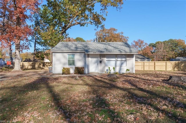 rear view of property with a yard