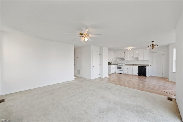 unfurnished living room with light hardwood / wood-style flooring and ceiling fan with notable chandelier