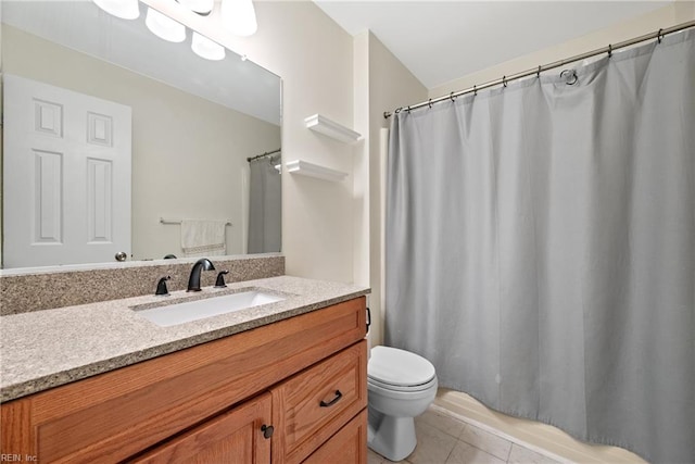 bathroom featuring toilet, vanity, and tile patterned floors