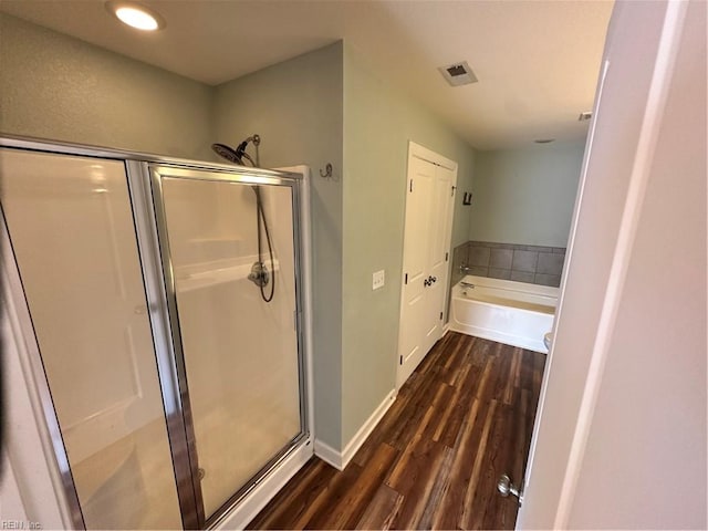 bathroom featuring hardwood / wood-style flooring and shower with separate bathtub