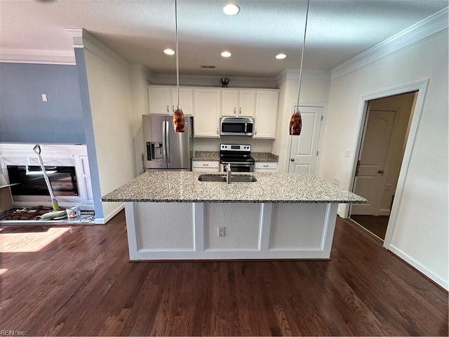 kitchen featuring light stone counters, white cabinetry, stainless steel appliances, and dark wood-type flooring