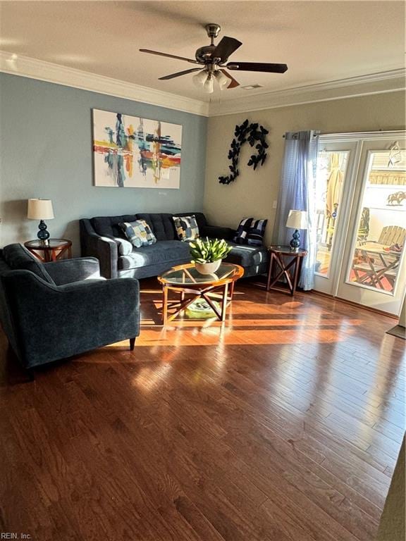 living room with crown molding, ceiling fan, and wood-type flooring