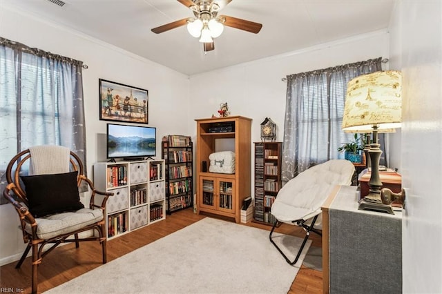 sitting room featuring hardwood / wood-style floors and ceiling fan