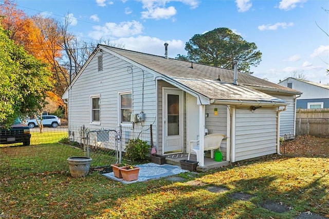 back of property featuring a lawn