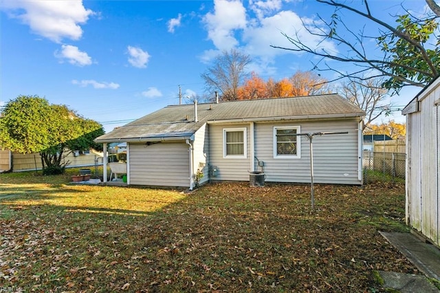 rear view of property with a yard