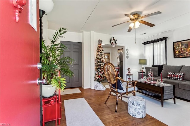 living room with dark hardwood / wood-style floors, a healthy amount of sunlight, and ceiling fan