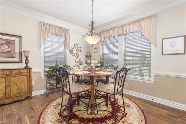 dining space with dark hardwood / wood-style floors and ornamental molding