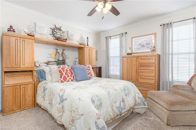 bedroom featuring ceiling fan, ornamental molding, and light colored carpet