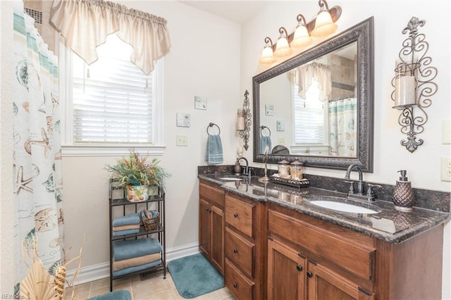 bathroom with vanity, tile patterned flooring, and curtained shower