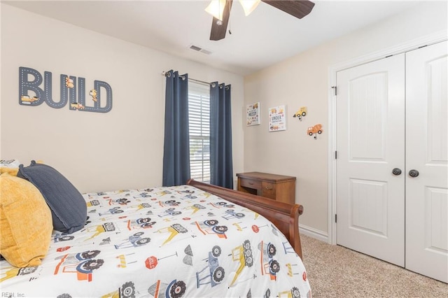 carpeted bedroom featuring a closet and ceiling fan