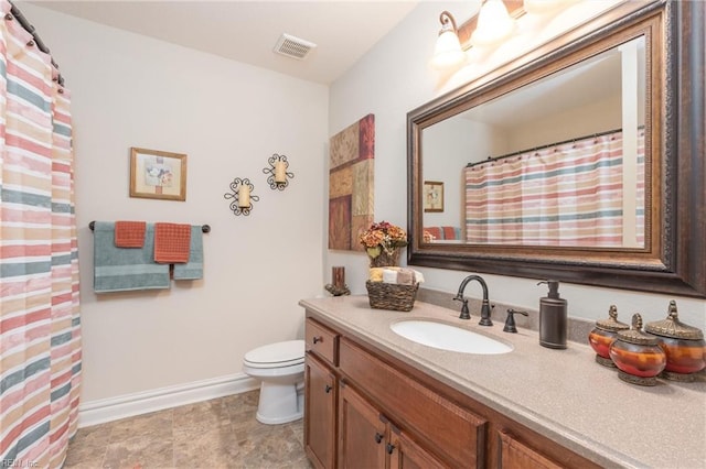 bathroom with toilet and vanity