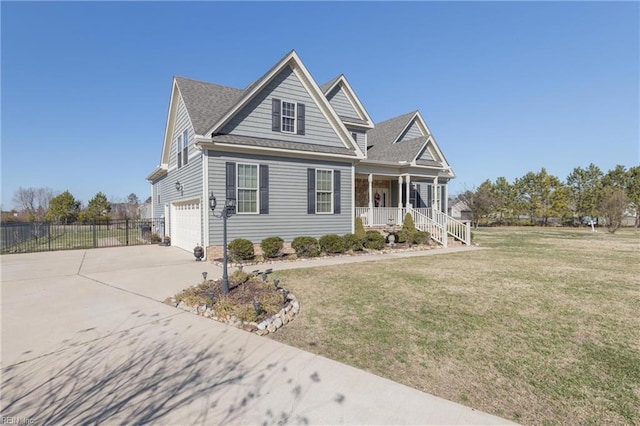 view of front of home with a front yard, a garage, and a porch