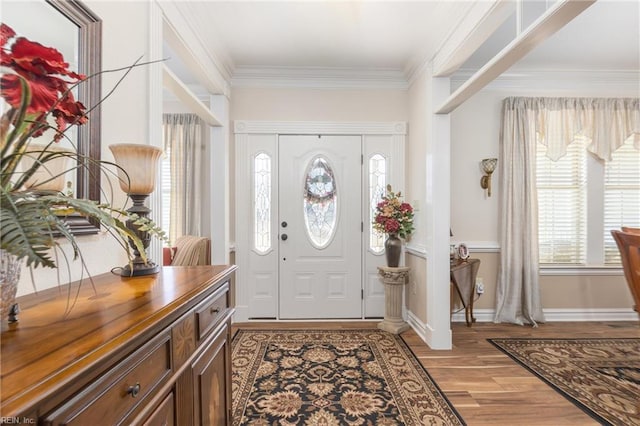 foyer featuring light wood-type flooring and crown molding